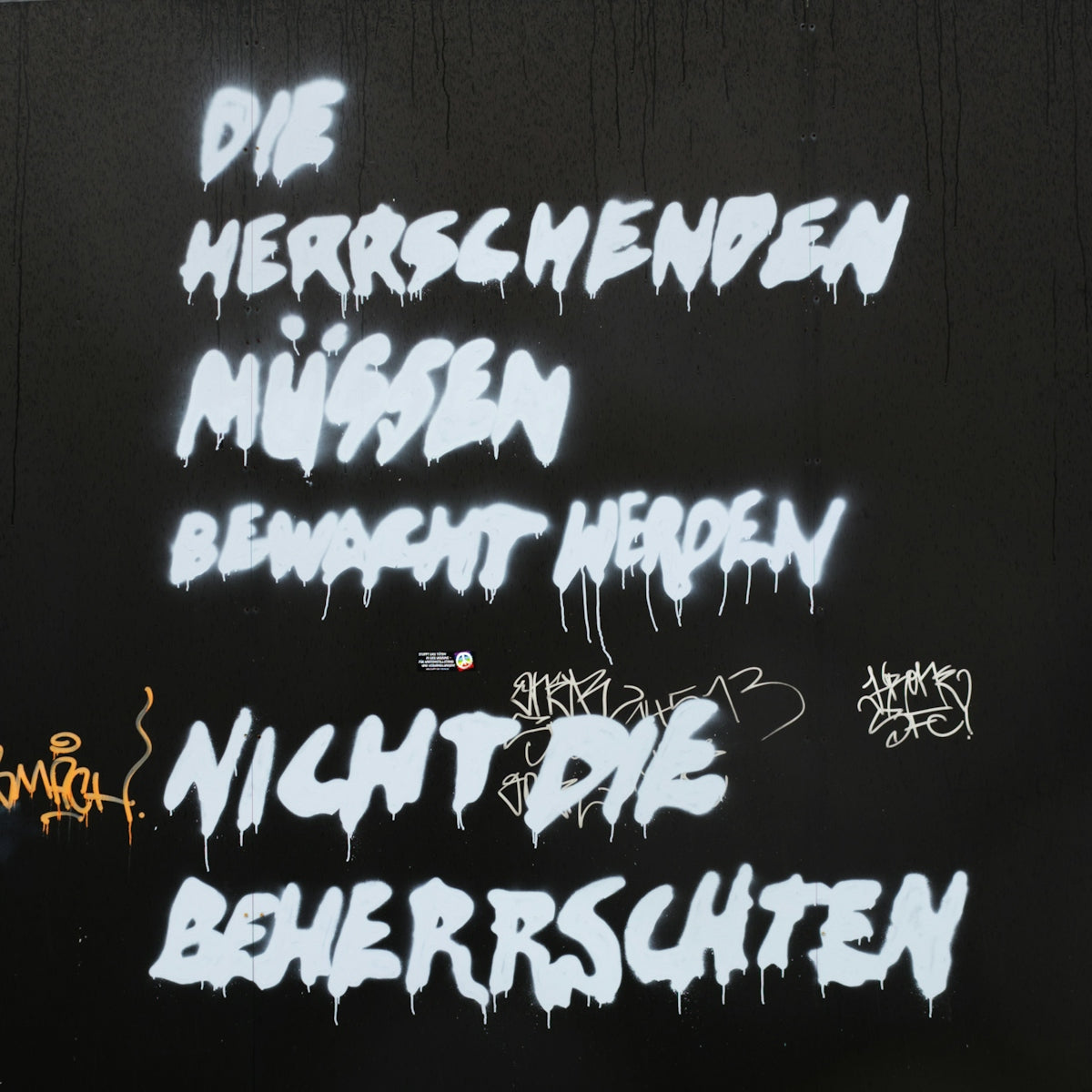 graffiti written on a wall in different languages